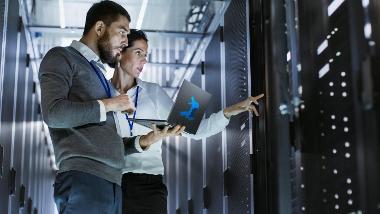 Image of two work colleagues looking at a network server