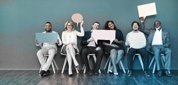 Image of 6 people sitting down holding up speech bubble templates Image of 6 people sitting down holding up speech bubble templates