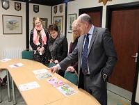 Image of judges looking at poster designs Image of judges looking at poster designs