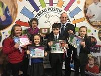 Image of judges and pupils with their poster competition prizes Image of judges and pupils with their poster competition prizes