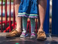 Image of people standing on playground equipment