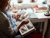 Image of a father and son looking at old photographs Image of a father and son looking at old photographs