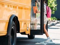 Image of a child stepping onto a bus