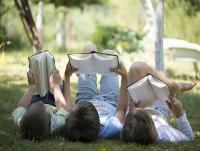 Image of children reading books outside