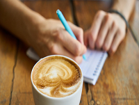 Image of a person in a cafe keeping a record