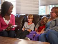 Image of a social worker with young family