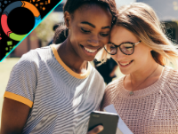 Image of two female teenagers looking at a mobile phone
