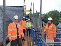 Image of people at the topping out ceremony at a new affordable housing development in Clyro