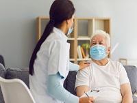 An elderly man receiving care in his home