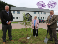 Cllr. Iain McIntosh planting an apple tree