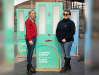 Image of Emma and Caroline with a door