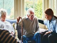 Image of a carer laughing with an older couple