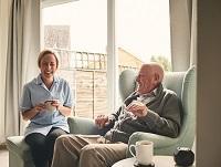 Image of a carer laughing with an older man