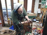 Image of a volunteer refurbishing tools