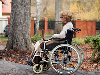 Image of a lady in a wheelchair using a laptop
