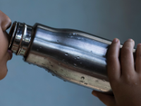 Image of a person drinking from a water bottle