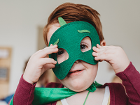 Image of a little boy with a superhero mask