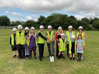 Image of people at turf-cutting ceremony for Ysgol Cedewain