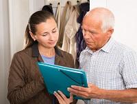 A social worker explaining options to an elderly man