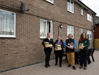 Image of representatives from Powys County Council, SWG Construction and Montgomeryshire Wildlife Trust are pictured with the wildlife boxes outside Buckley House.