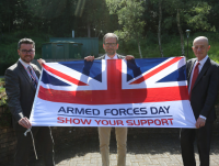 Pictured with the Armed Forces Day Flag is (from left to right) Cllr Matthew Dorrance, Deputy Leader and Armed Forces Champion; and Cllr James Gibson-Watt, Leader; and Jack Straw, Interim Chief Executive.