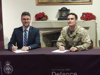 Cllr Matthew Dorrance and Maj Tim Hearne signing the covenant
