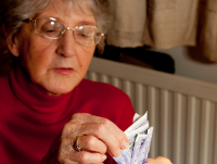 An elderly woman counting her money