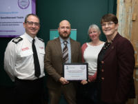 Image of the Powys Ukrainian Resettlement Team with the Equalities, Inclusion and Cohesion Award that the team won at the 2024 Safer Communities Awards. 