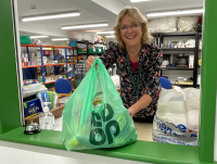 A volunteer handing out a food parcel at Llandrindod Foodbank