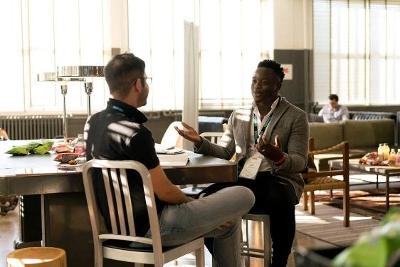 Two men sat at a table having a conversation