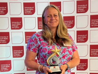 Image of Lizzie Tiernan, Head of Sixth Form at Ysgol Calon Cymru, proudly receives the Supporting Progression into Higher Education award at the 2025 Teachers’ and Advisers’ Awards in Cardiff
