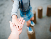 A child holding an adult's hand
