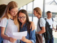 Image of two girls sharing exam results