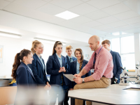 Image of a teacher and secondary school pupils