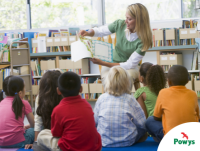 Image of a teacher reading to children