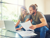 Two people checking their housing costs