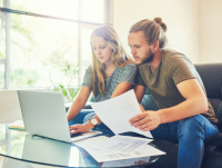 Two people checking their housing costs