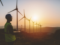 Wind turbines with the sun shining behind them