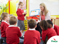 Image of a teacher and primary school children