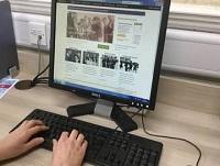 Image of someone doing research on a computer Image of someone doing research on a computer