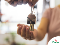Image of a person receiving keys with a house key ring