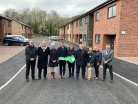 Image of representatives from Powys County Council, J Harper and Sons and Newtown and Llanllwchaiarn Town Council attended the official opening of new council housing development in Newtown – Clos Robert Owen.