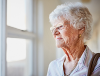 An older person looking out of a window
