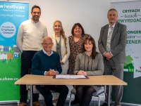 Russell Brown, Shaw Healthcare’s Chief Executive Officer and Nina Davies, Powys County Council’s (PCC) Director of Social Services and Wellbeing signing the new 15-year contract. With them are back row, from left to right: Geraint Evans, Shaw’s Operations