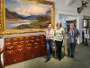 Left to right: Lorna Steel (Curator), Deborah Price and Rebecca Jones (Community, Culture and Digital Officers). Painting of Nant Gwyllt by Alfred East. 