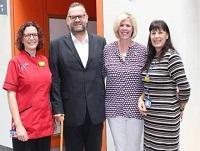 Image of John Bevan with his wife and nursing staff