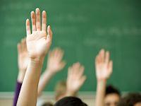 Images of hands in the air in a classroom