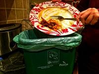 Image of food waste going into a food bin Image of food waste going into a food bin