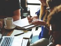 Image of people meeting round a table