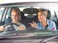 Image of a young person driving with an instructor in the passenger seat
